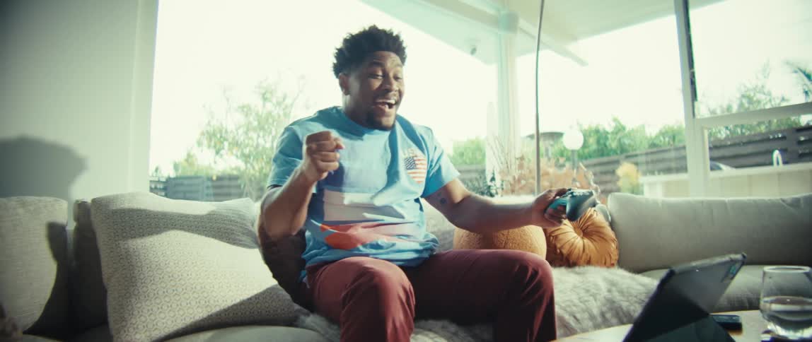 Man sitting on a couch playing video games