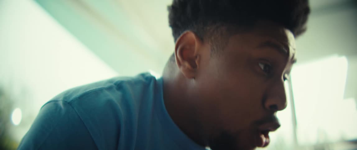 Man in blue shirt with intense expression and mouth open