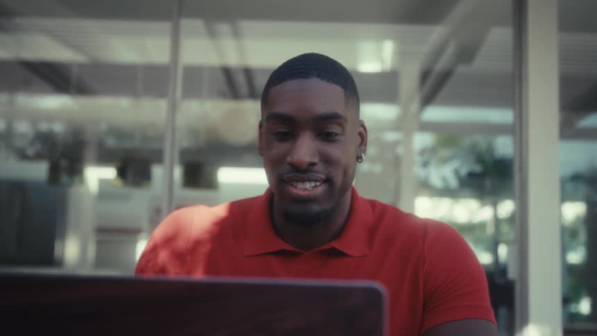 A man outdoors using a laptop