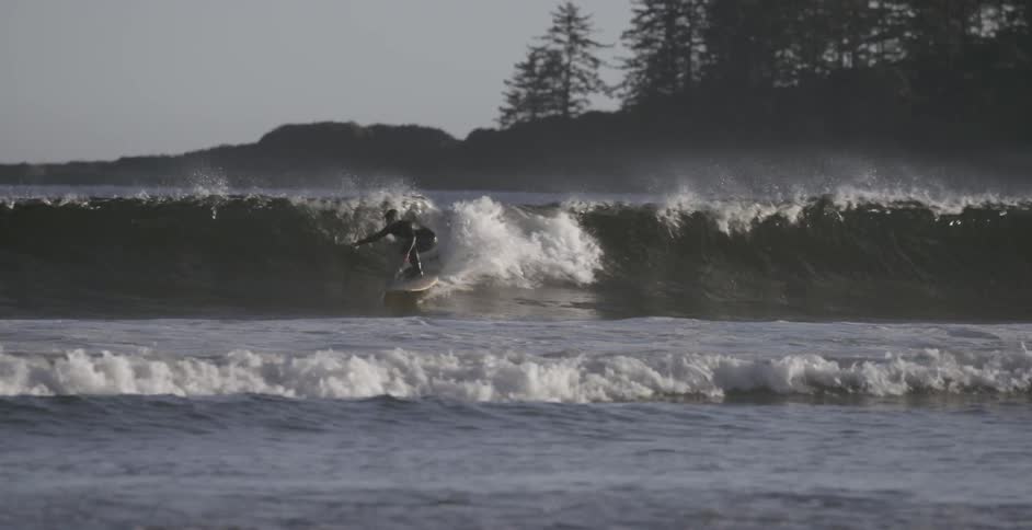 A surfer rides a wave in