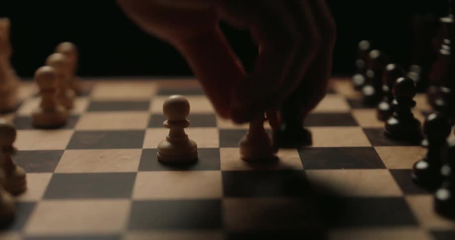 The player takes a chess piece from the board
