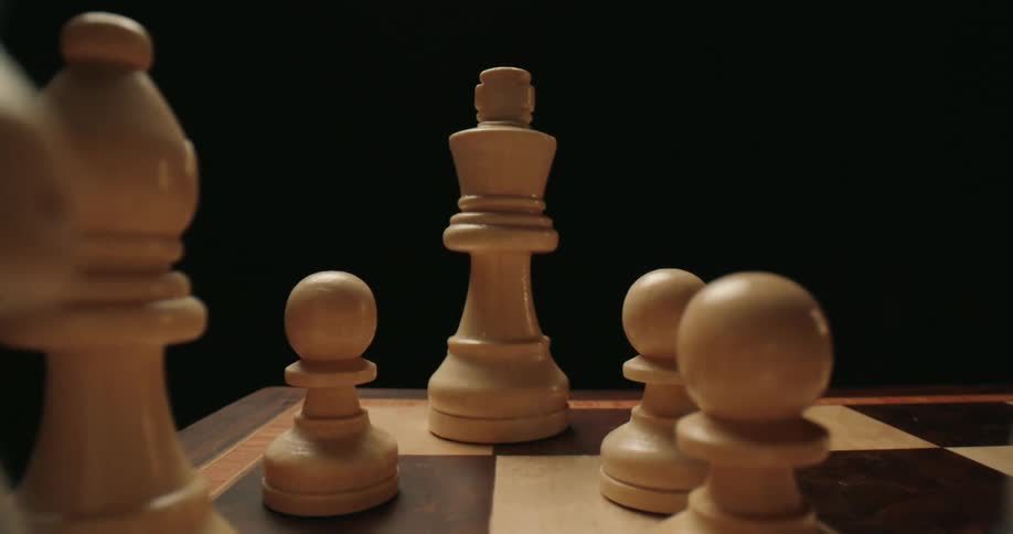 Chess pieces displayed over a chess board indoors