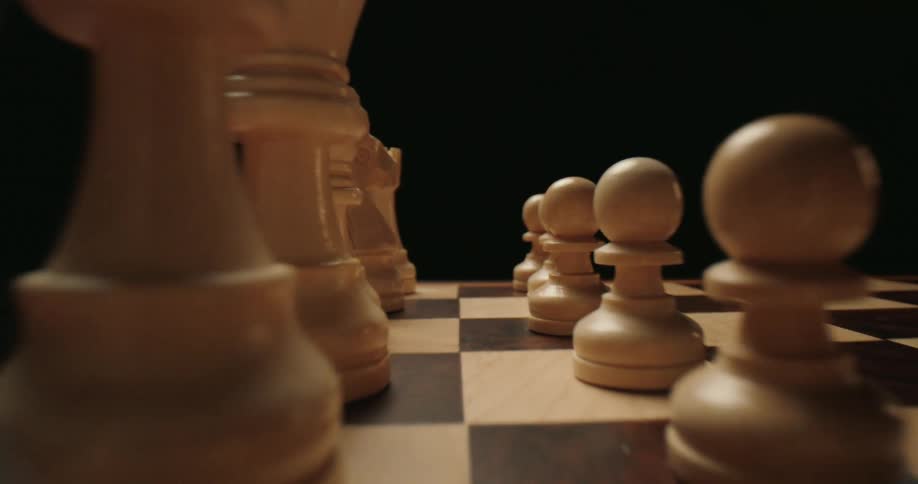A close up of a chess board with pieces