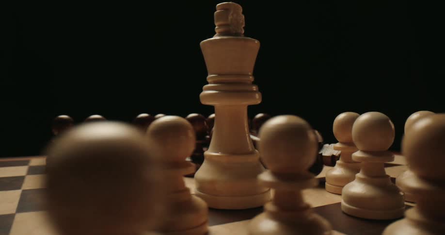 A persons completes checkmate while playing chess