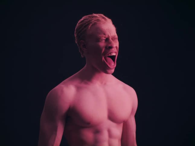 A man screaming while standing in a room