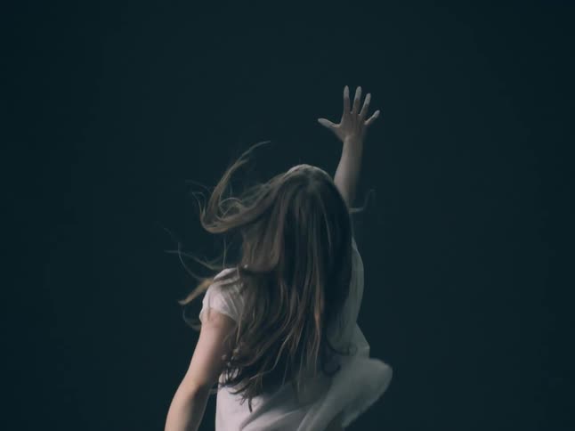 A woman reaching for something in the distance