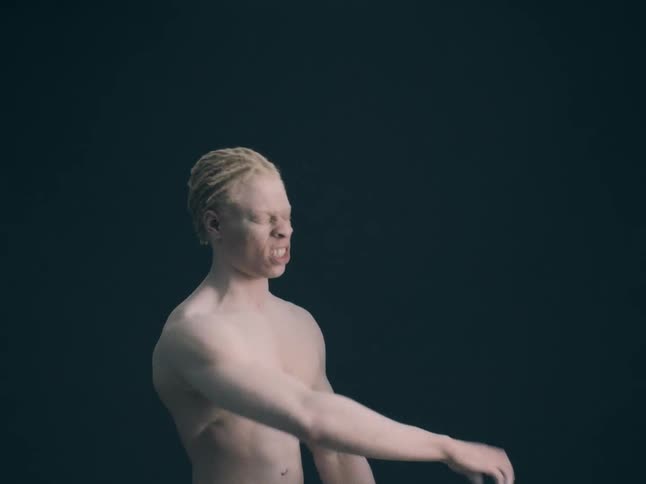 A man screaming and punching the air