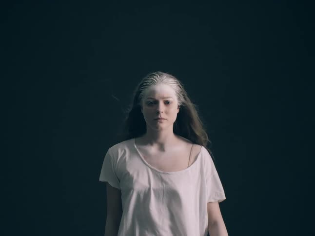 A woman walking towards a camera