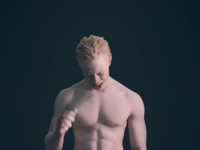 Young adult man moving his hand with a sad and nervous facial expression indoors