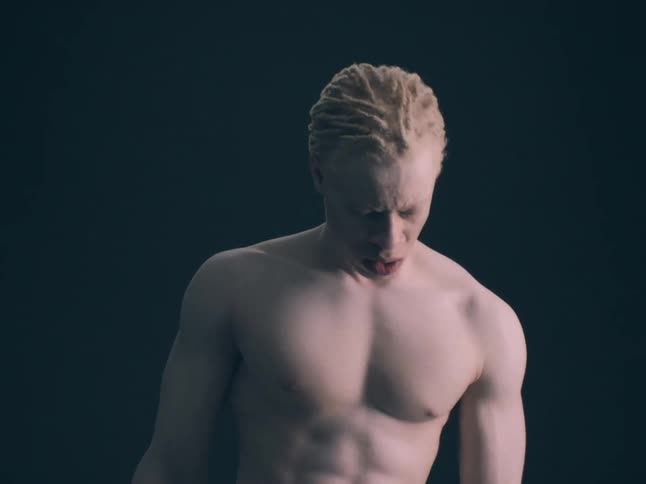 The shirtless man is dancing