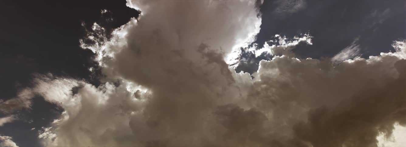 Cumulus clouds move across the night sky