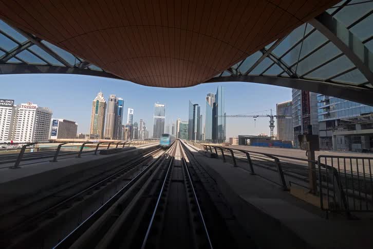 A view of a train running down tracks in a city