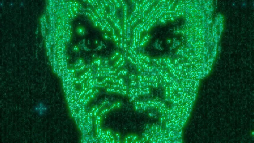 A digital representation of a human face emerges from scrolling green binary code and circuit patterns on a dark screen