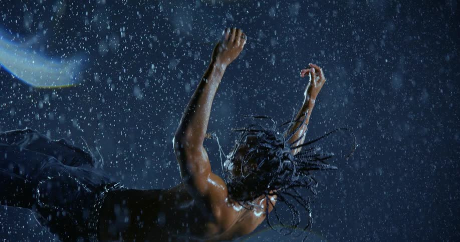 A man diving into water at night