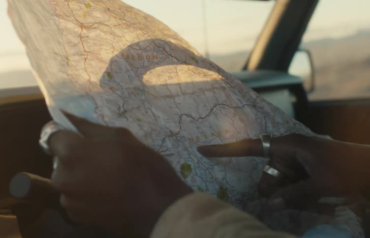A person reading a map while sitting in a car
