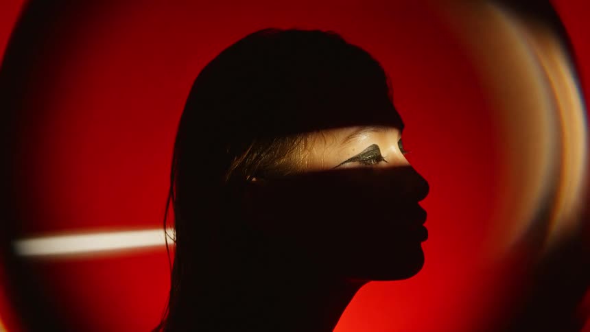 A light only shows a models eyes as she poses