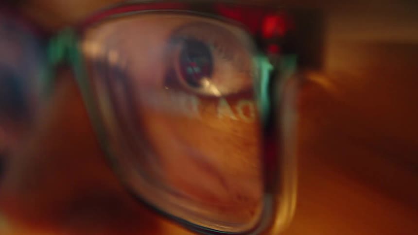 A person looking at a screen with glasses on