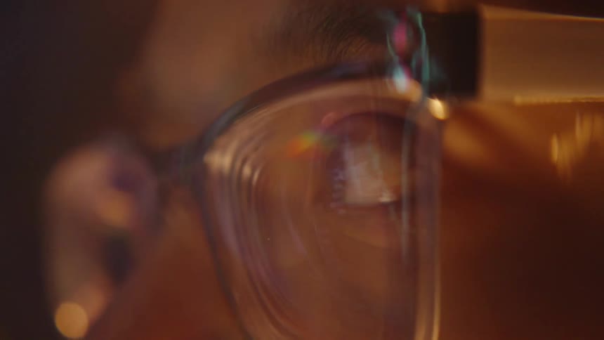 Reflection of illuminated screen on eyeglass lens in close focus