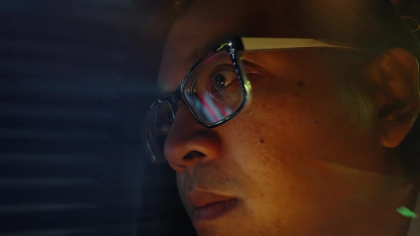 The man is reading the information on the monitor