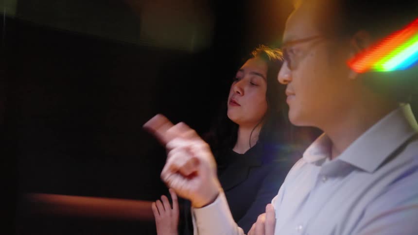 A man and woman looking at a computer screen