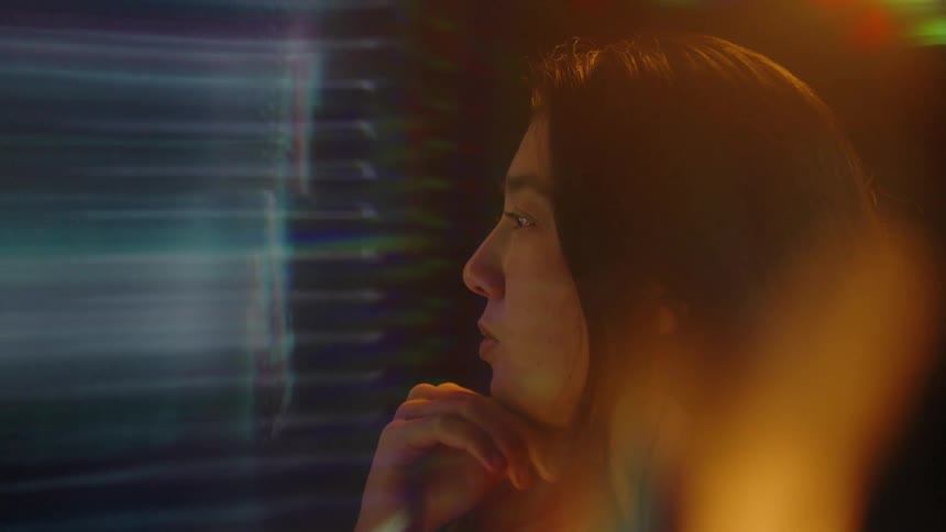 A woman looking at a screen in a room