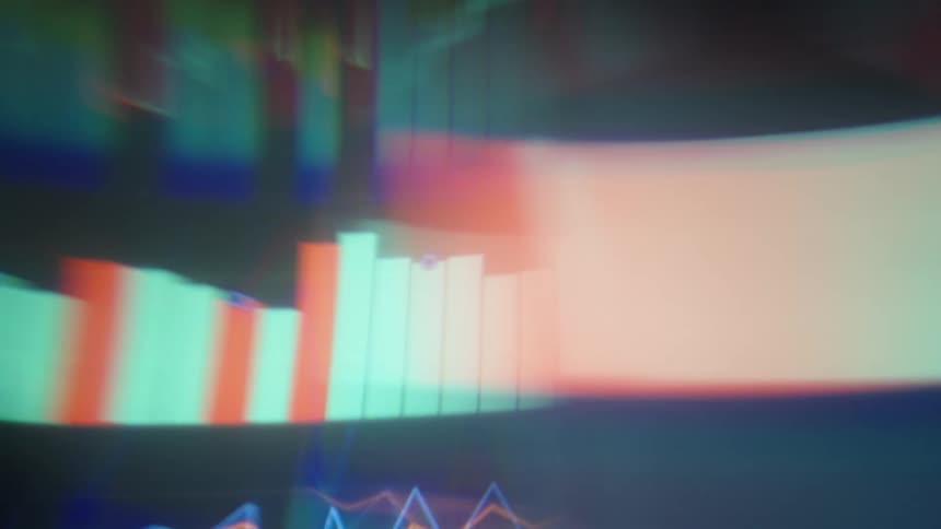 Blurred financial graphs on a screen indoors