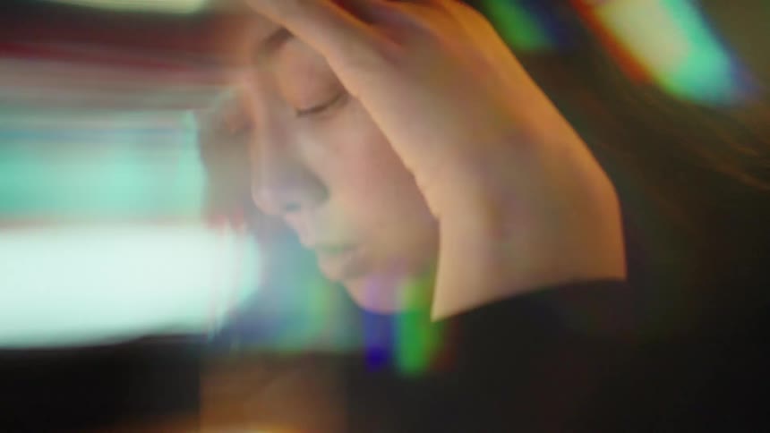 The woman is frustrated while looking at her laptop
