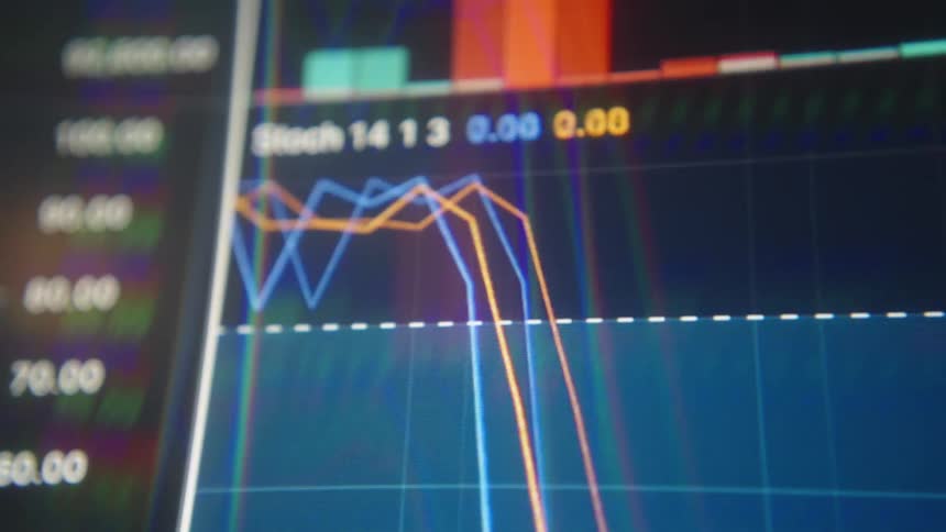 Line graphs and numbers move across the monitor