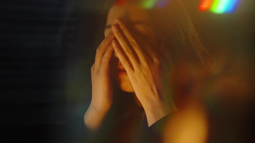 The tired woman rubs her face