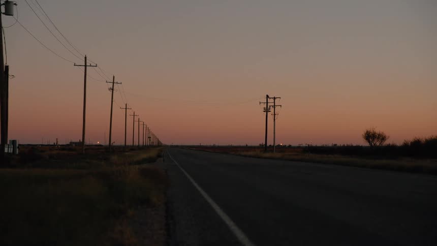 Power lines are on both sides of the highway