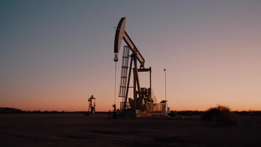 The drilling rig is working at sunrise