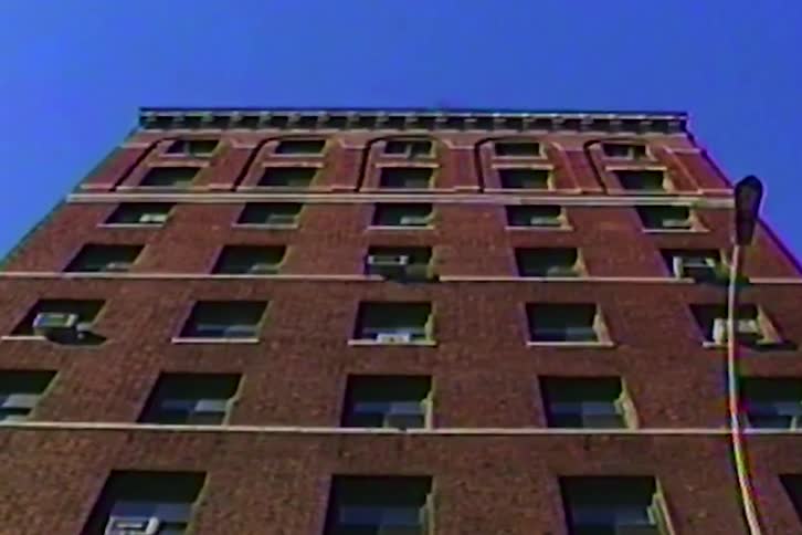 The tall apartment building is made of bricks