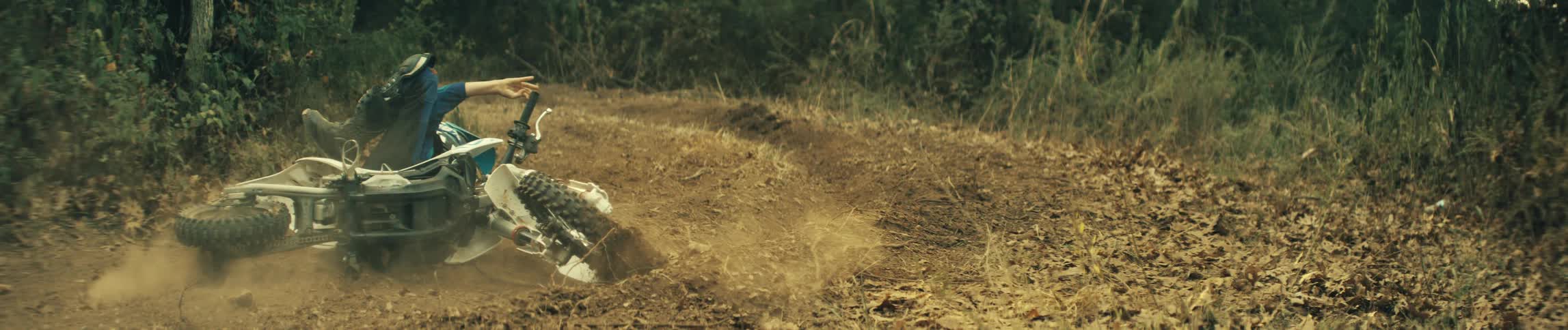 A person falling off of a dirt bike