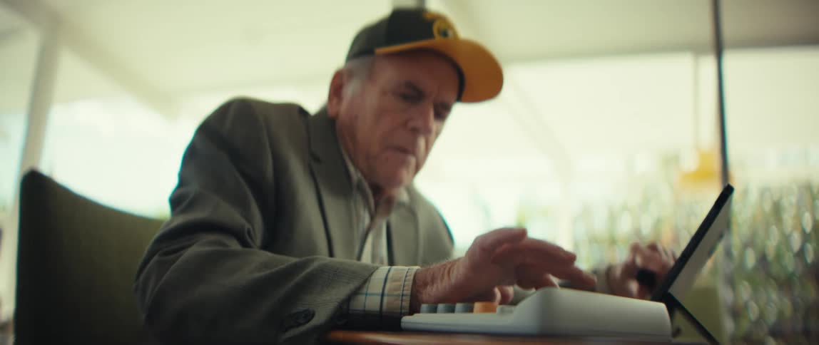 A man typing on a tablet