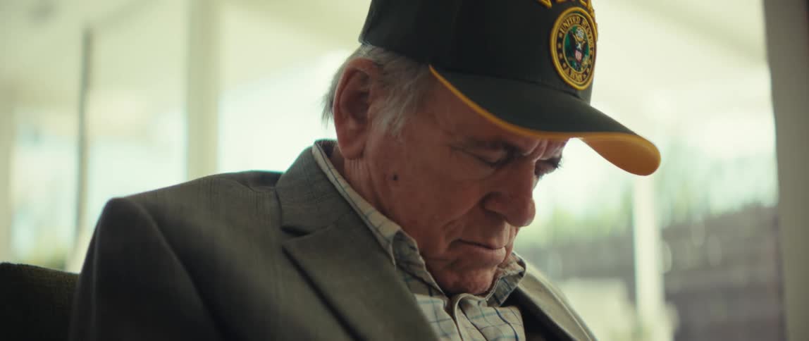 Elderly man wearing a cap while sleeping