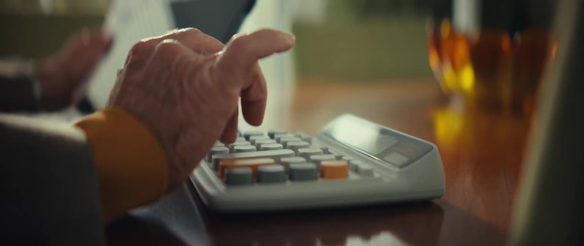 A person typing on a keypad