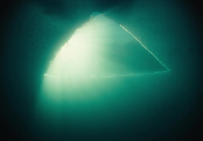 A triangularshaped piece of ice is cut out in a frozen body of water