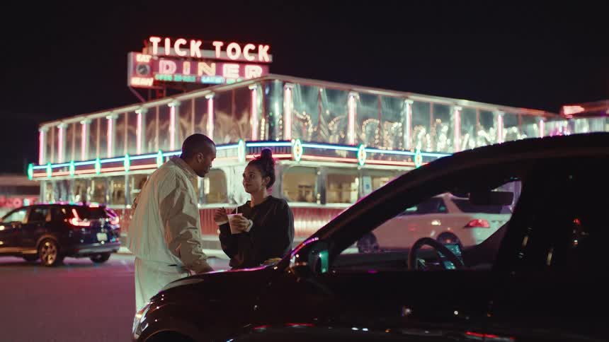 A couple sharing a drink outside