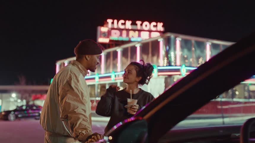 A couple hanging out at night