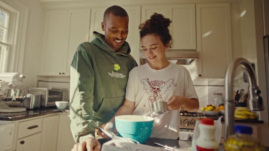 A couple cooking together in a kitchen