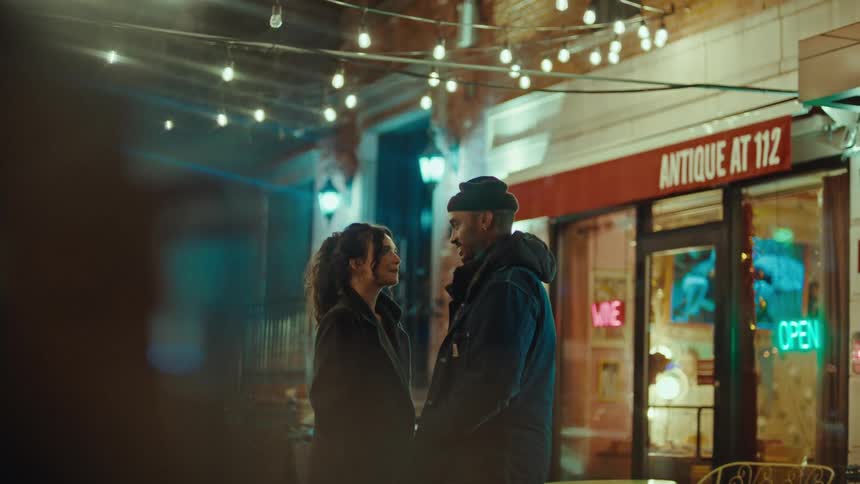 A man and woman kissing each other outdoors