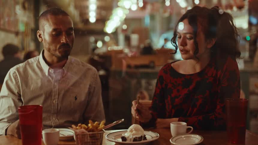 Man and woman eating and drinking in a restaurant