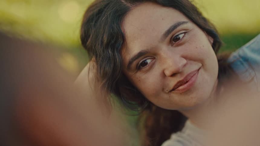 A woman smiling at something off camera