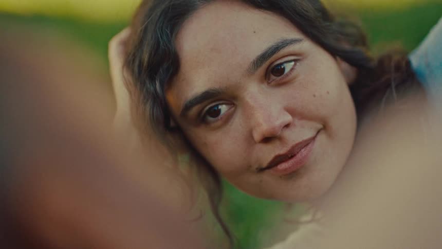Woman laying on the grass and talking