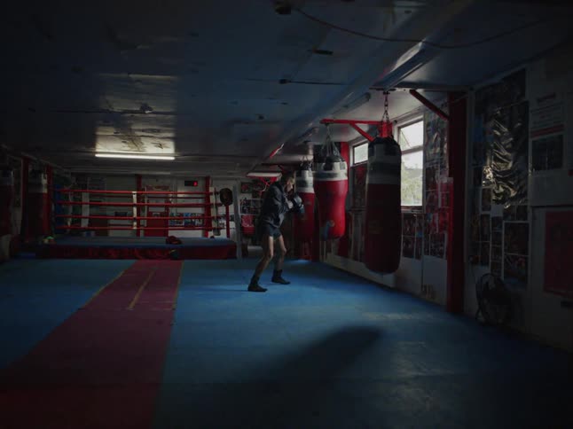A man practicing boxing with a bag