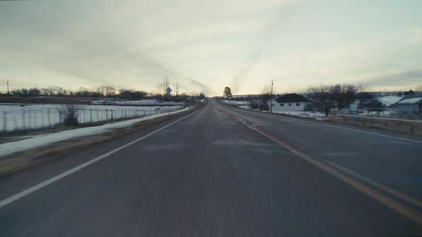 A view of snow on either side of a road