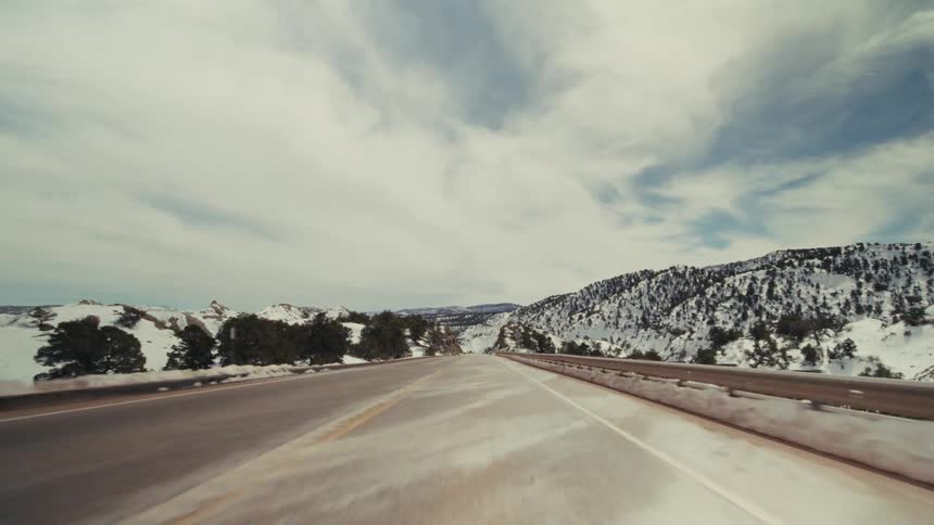 A view of a road on a mountain covered in snow