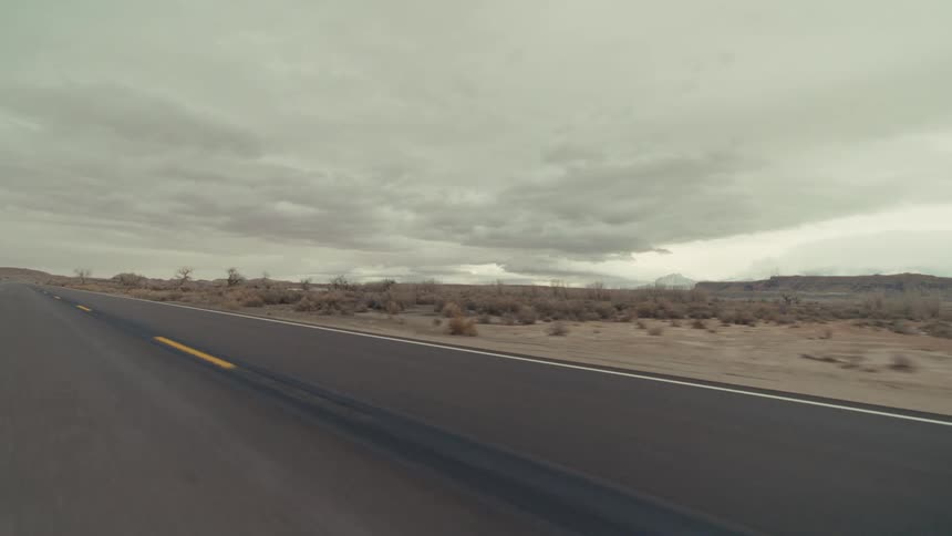 A view of a desert landscape next to a road