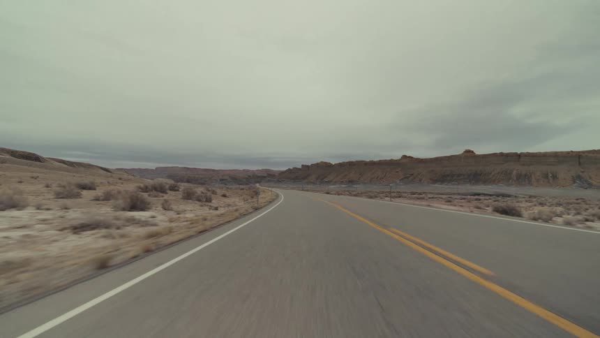 Traveling on a desert road through mountains and canyons