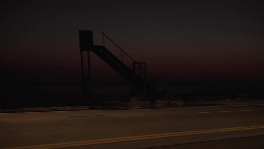 Road next to a beach outdoors during dusk or dawn